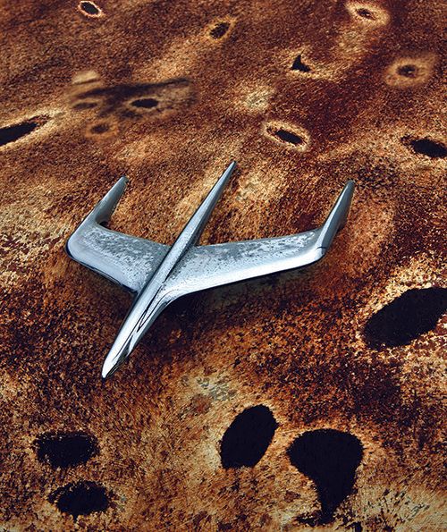 a composite image of a hood ornament on a rusty car hood.
