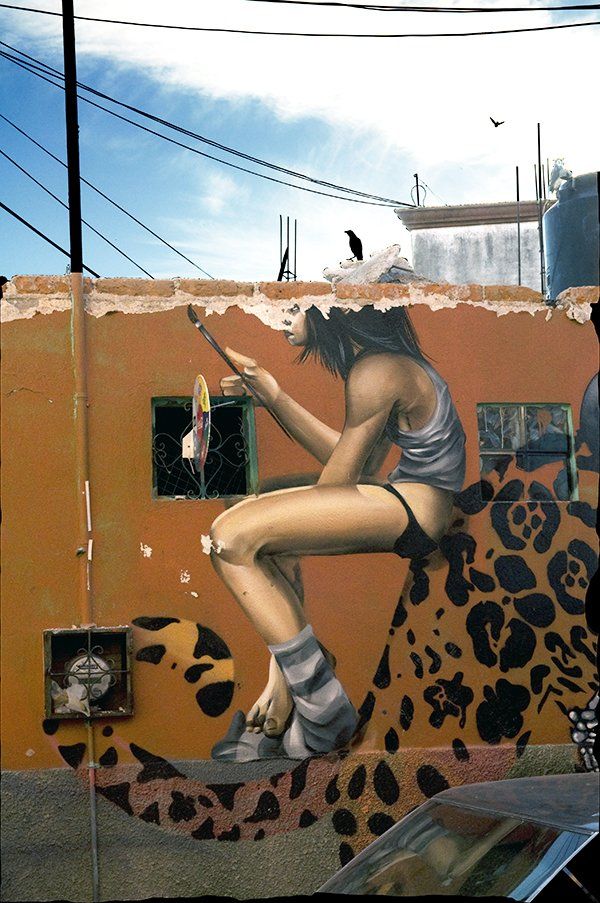 photo of a mural of a girl on a tiger