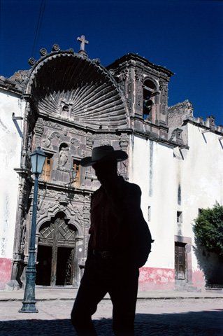 Silhouette of man in front of a Cathedral