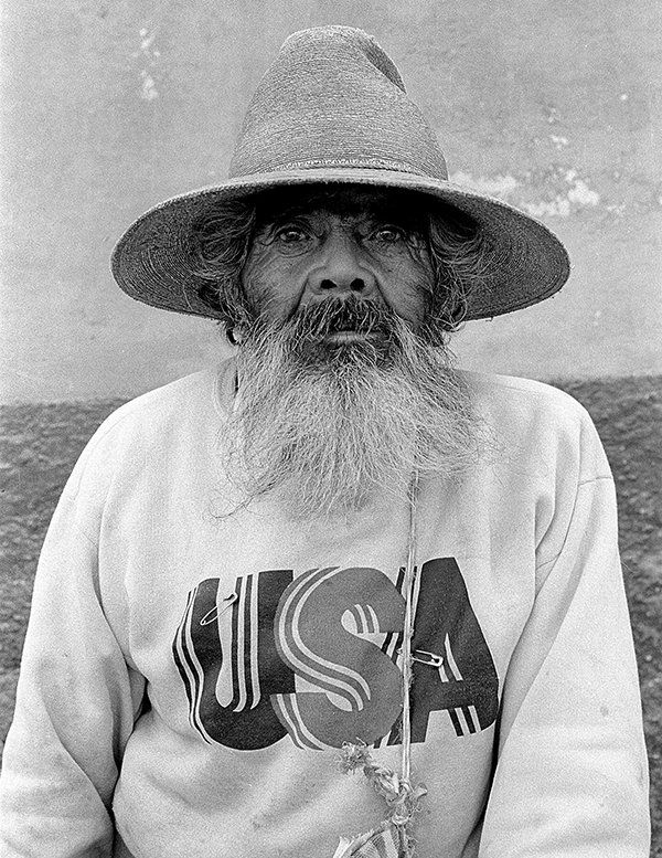 a documentary photo of Mexican man wearing a USA shirt.