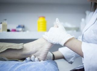 Diabetic Wound Care — Doctor Checking The Foot in Orlando, FL Diabetic Wound Care — Doctor Checking The Foot in Orlando, FL