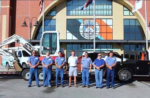 A group of men standing in front of a building