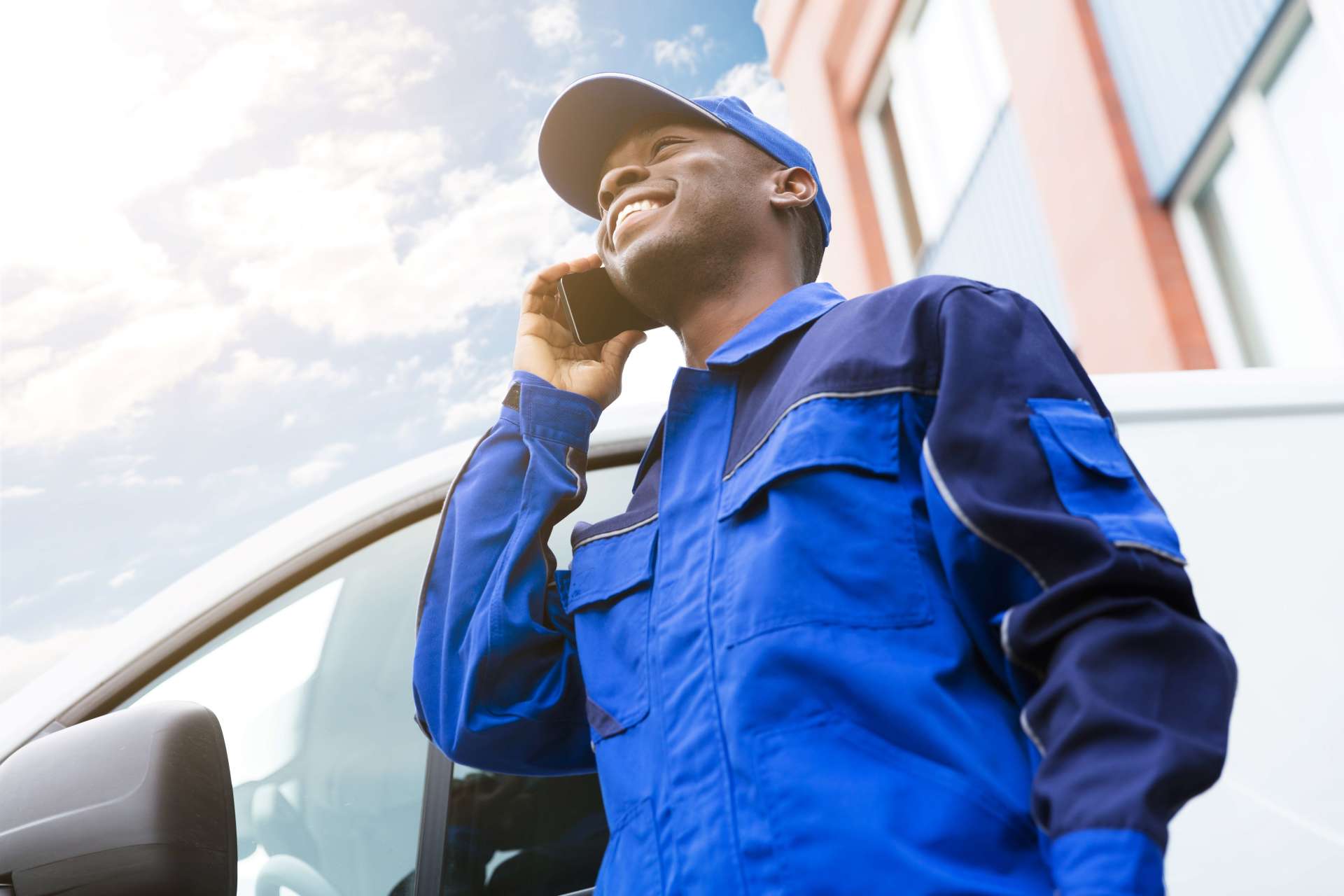 commercial plumber standing beside his vehicle