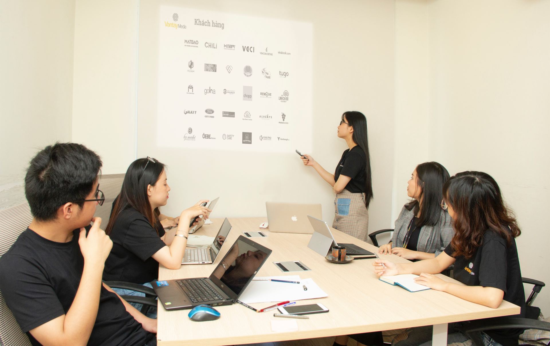 photo of a group of people in a training room looking at a slide show