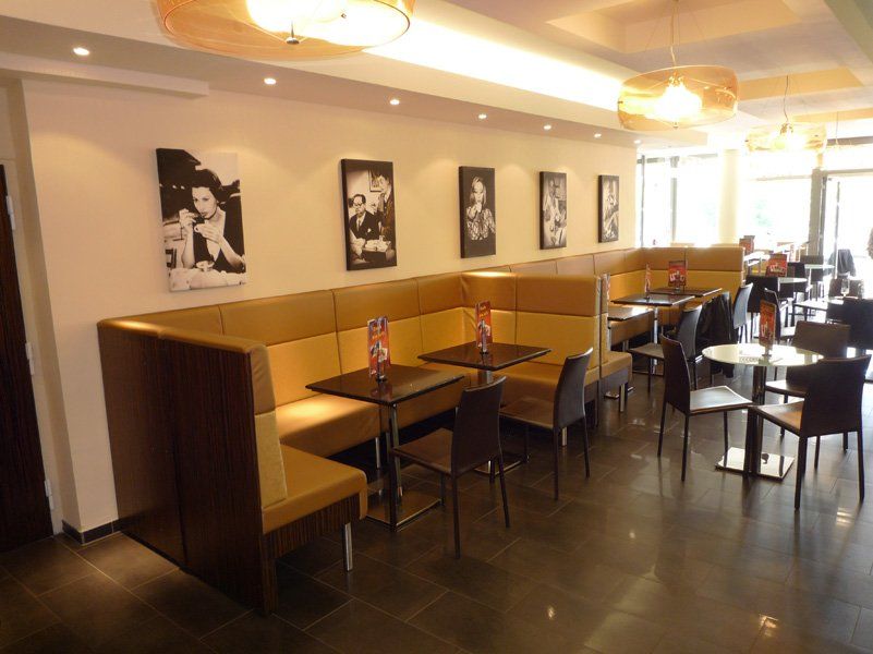 Bar mit goldfarbenen Sofas, Tischen und Stühlen