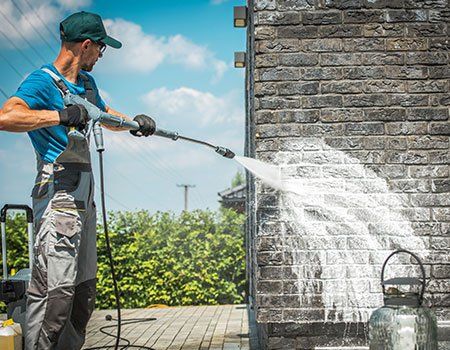 Worker Cleaning Brick Wall — Apollo, PA — T. D. Brick Pointing, LLC Worker Cleaning Brick Wall — Apollo, PA — T. D. Brick Pointing, LLC