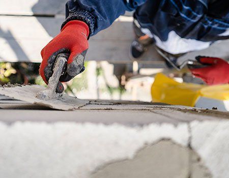 Worker Plastering a Wall with Trowel — Apollo, PA — T. D. Brick Pointing, LLC Worker Plastering a Wall with Trowel — Apollo, PA — T. D. Brick Pointing, LLC