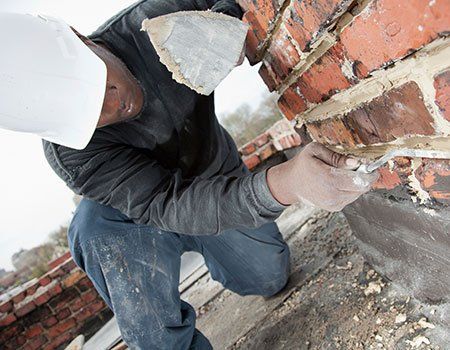 Man Using Trowel to Add Mortar — Apollo, PA — T. D. Brick Pointing, LLC Man Using Trowel to Add Mortar — Apollo, PA — T. D. Brick Pointing, LLC