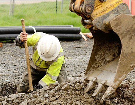 Worker Digging Dirt Out — Apollo, PA — T. D. Brick Pointing, LLC Worker Digging Dirt Out — Apollo, PA — T. D. Brick Pointing, LLC