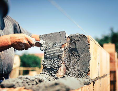 Construction Worker Installing Bricks — Apollo, PA — T. D. Brick Pointing, LLC Construction Worker Installing Bricks — Apollo, PA — T. D. Brick Pointing, LLC