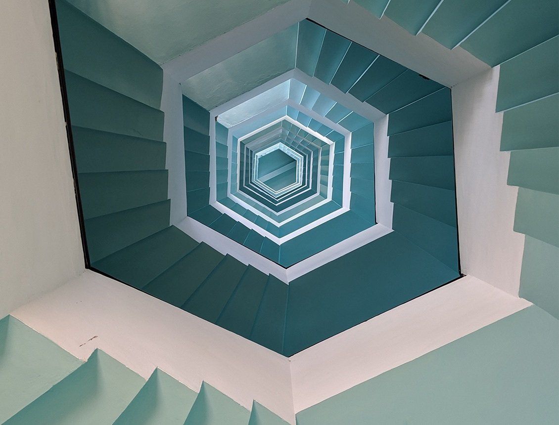 Looking up at a spiral staircase in a building