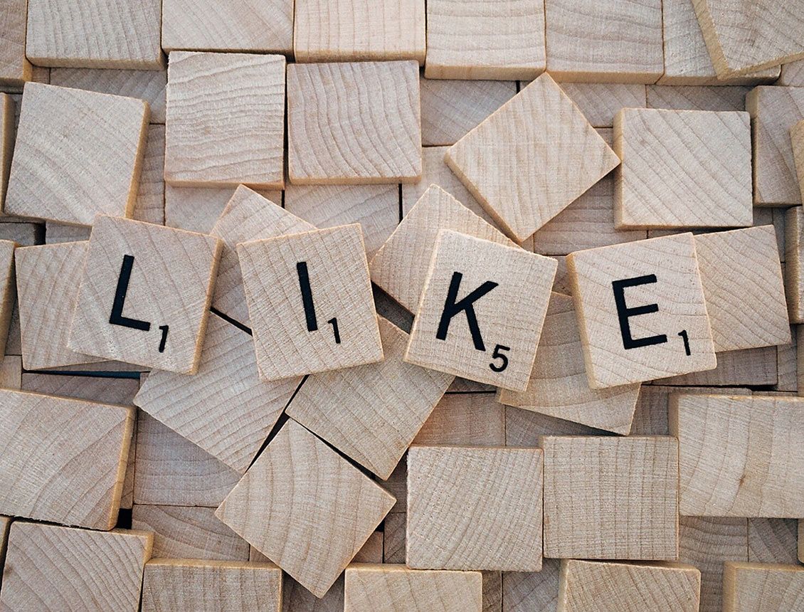 Close up scrabble tiles with the word like A pile of wooden tiles with the word like written on them