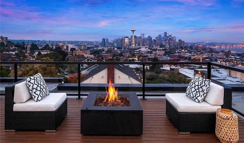Image of Seattle, city and space needle on top of a rooftop with firepit Image of Seattle, city and space needle on top of a rooftop with firepit
