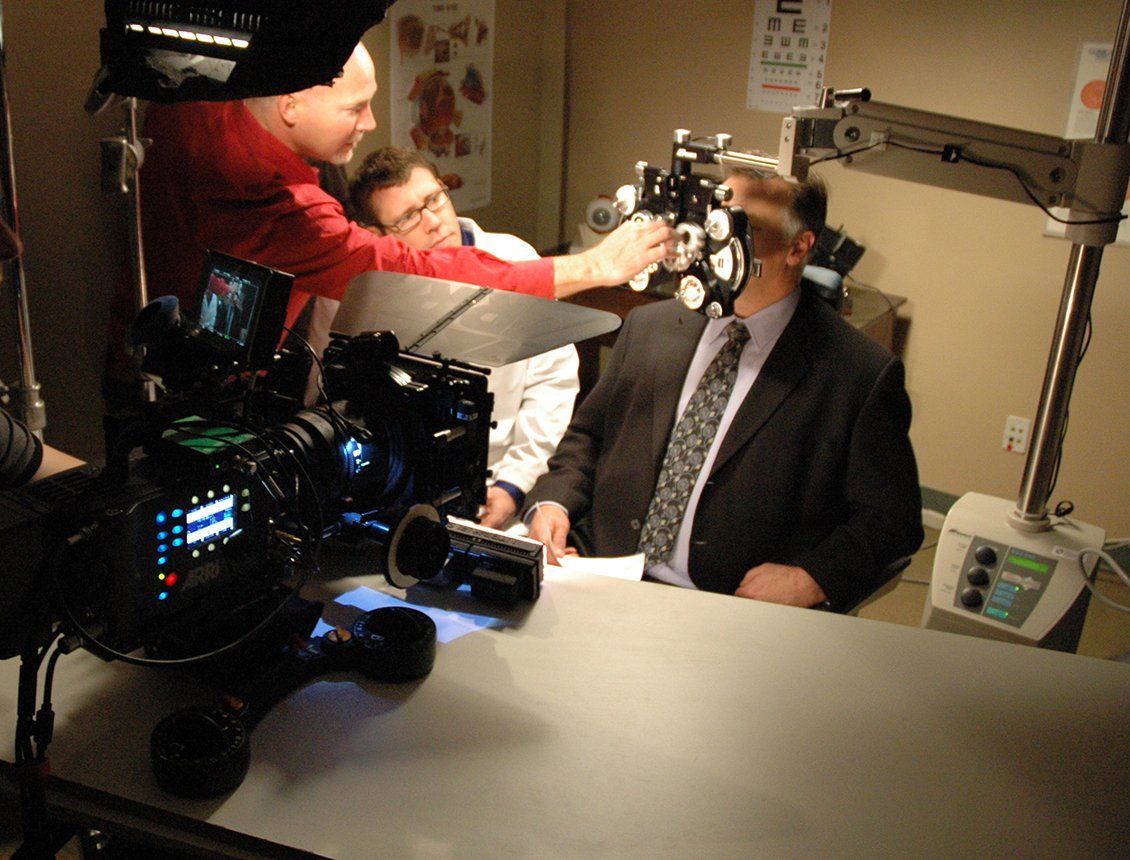 A man in a suit is being interviewed by a cameraman