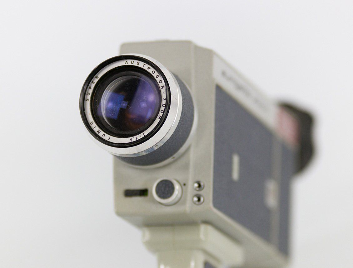 A close up of a video camera on a tripod