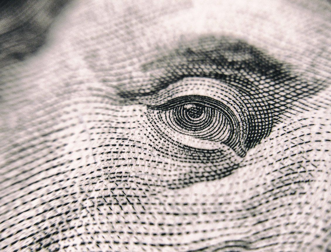 Close up money A close up of a dollar bill showing a man 's eye.