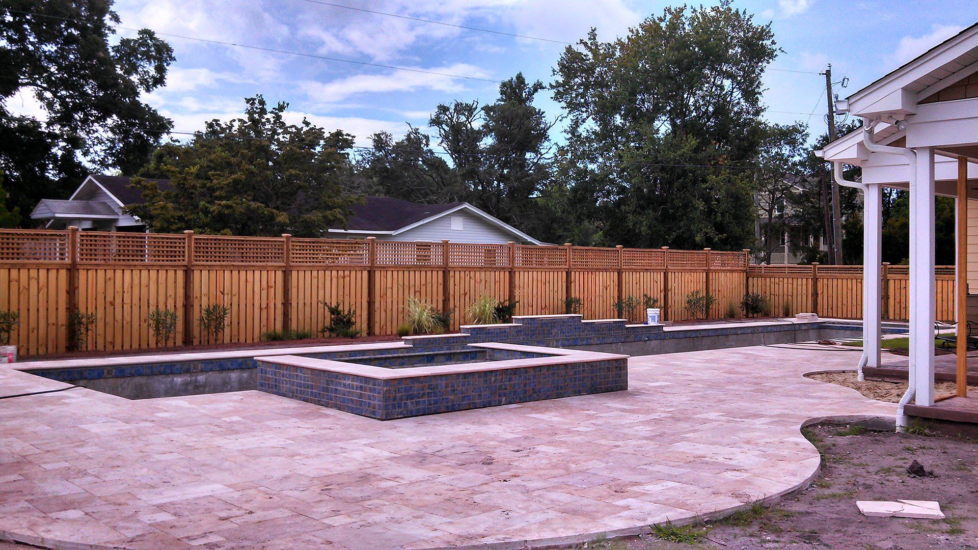 Elegant Pool With Wooden Fence — Wilmington,  NC — J & J Fence