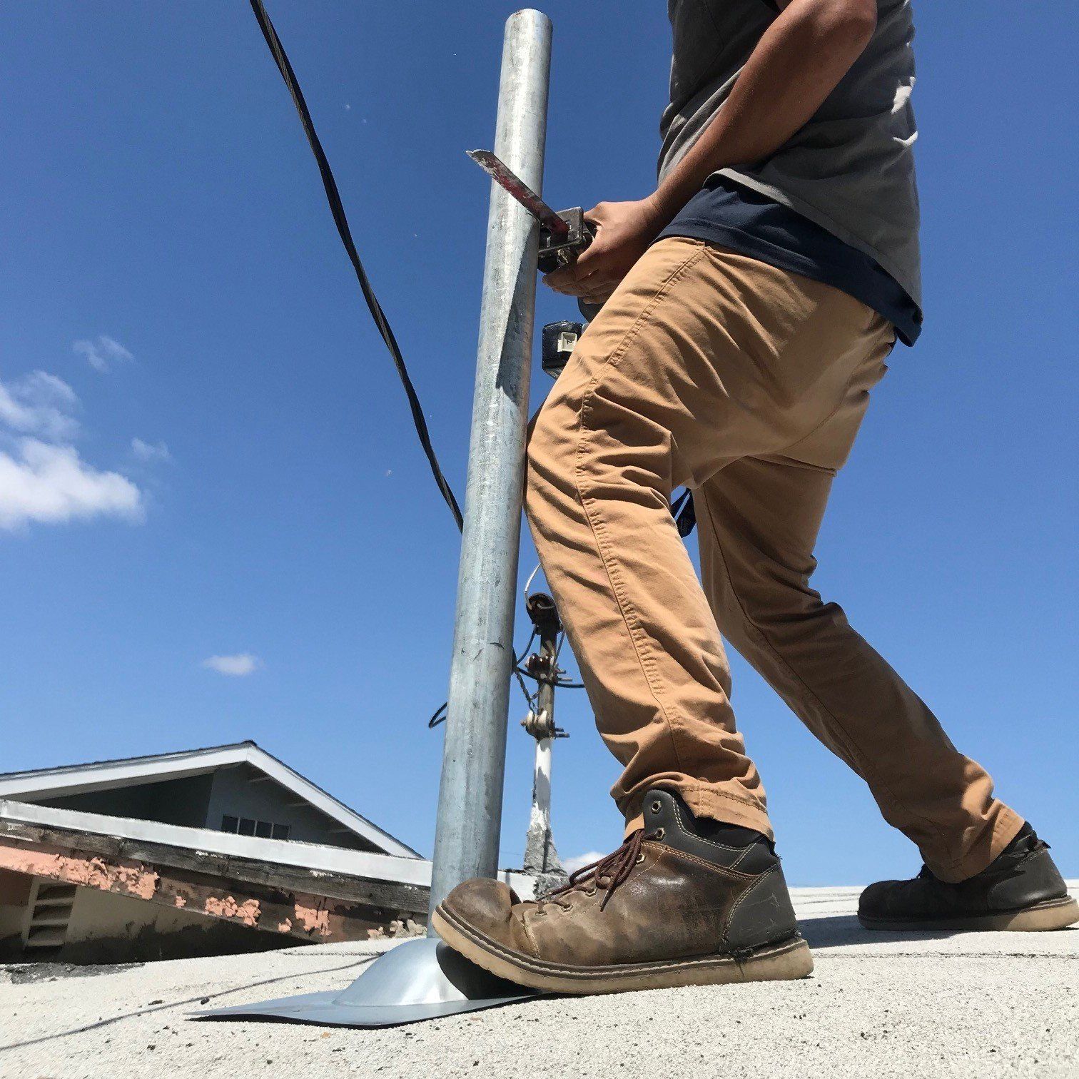 Electrician Sawing a Metal Tube — Riverside, CA — Volt Tech Electric