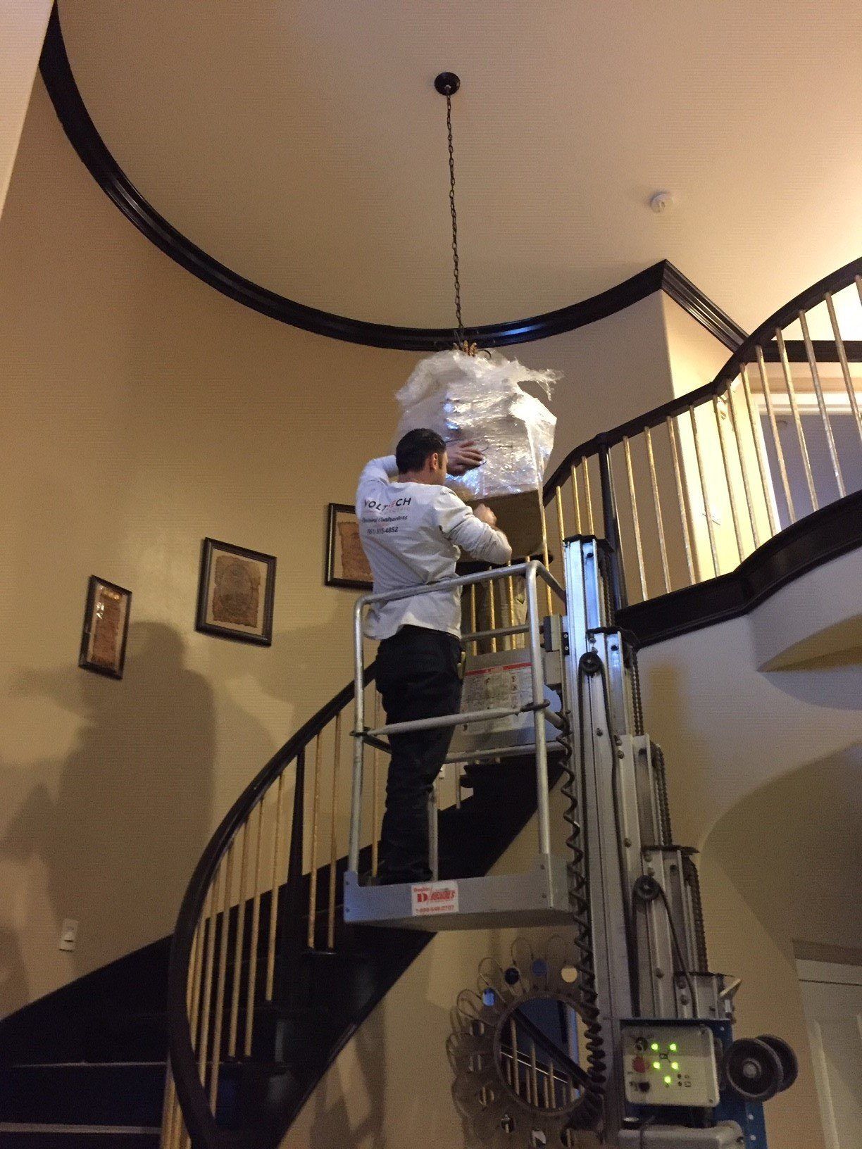 Man in Lift Equipment Installing Light Decoration — Riverside, CA — Volt Tech Electric