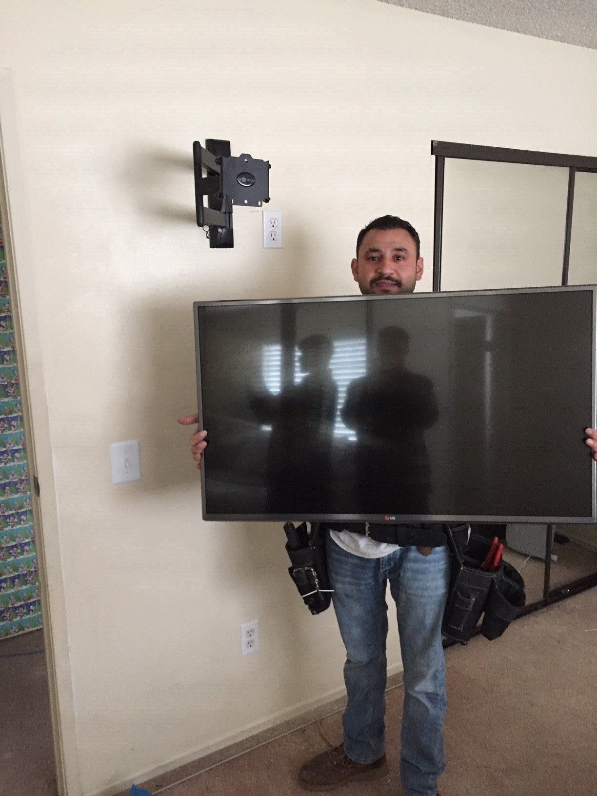 Electrician Mounting a TV — Riverside, CA — Volt Tech Electric