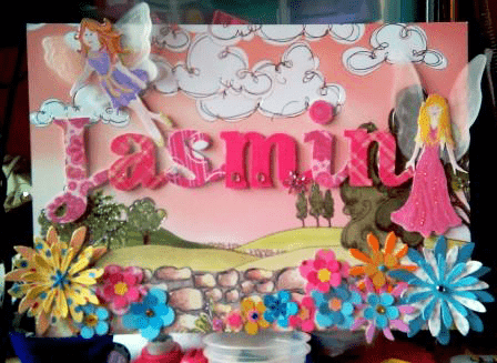 A4 sized card with countryside scene in the background and paper flowers and winged fairies in the foreground, featuring the name Jasmin in pink letters