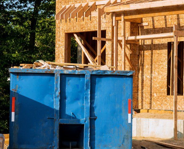 Dumpster Truck On Construction Site — Storm Lake, IA — Garbage Hauling Service Inc Dumpster Truck On Construction Site — Storm Lake, IA — Garbage Hauling Service Inc