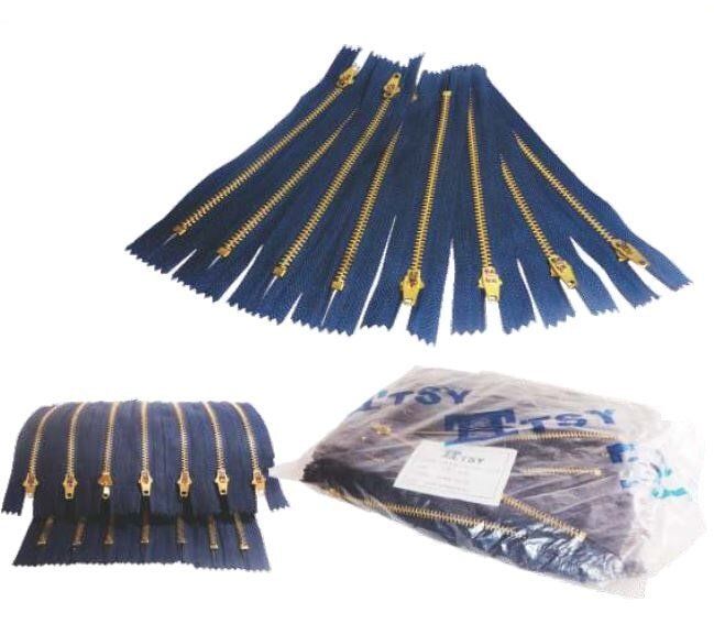 Blue pleated zipper pouch with gold zippers, shown open and folded, plus a packaged set.