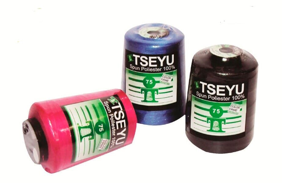Three TSEYU thread spools in pink, blue, and brown on a white background