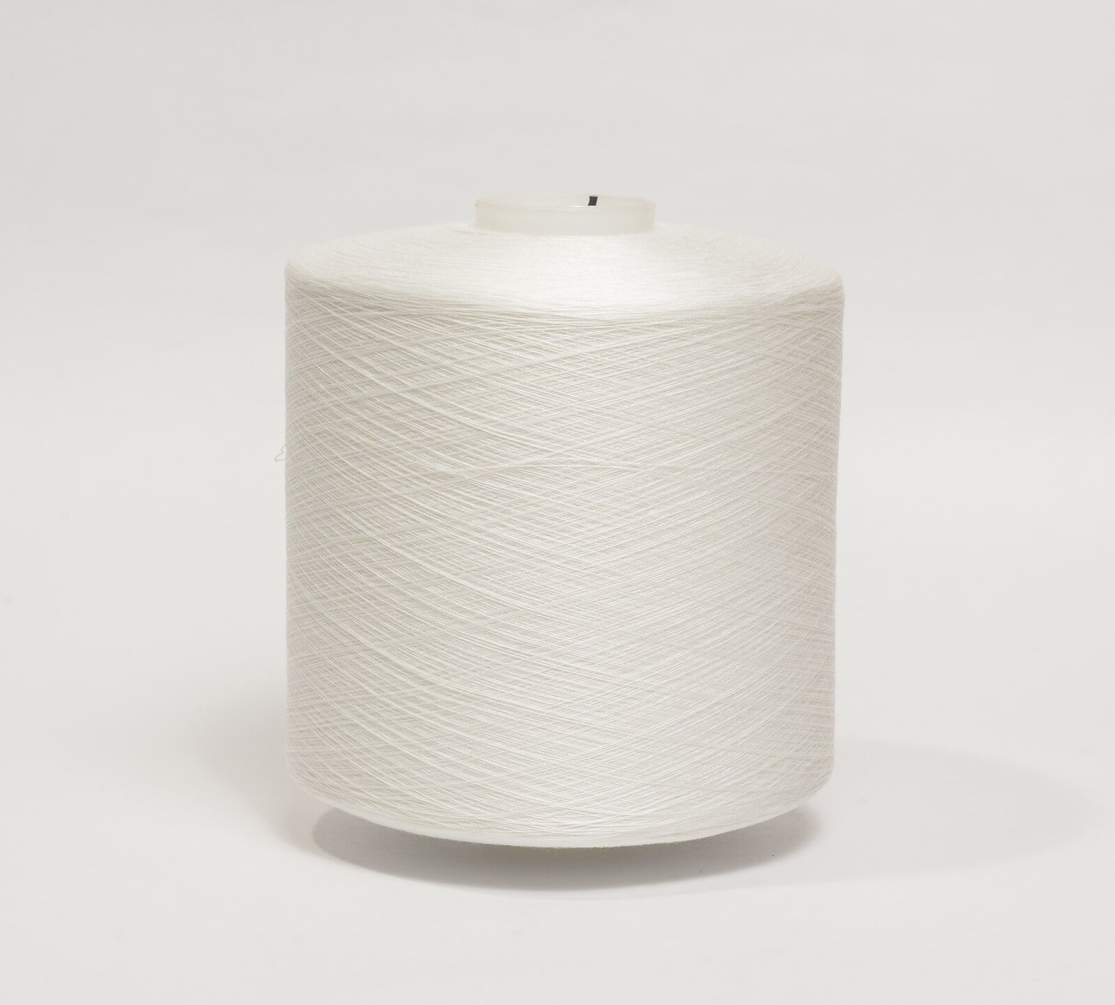 White cylindrical roll of textured paper or fabric on a plain light background