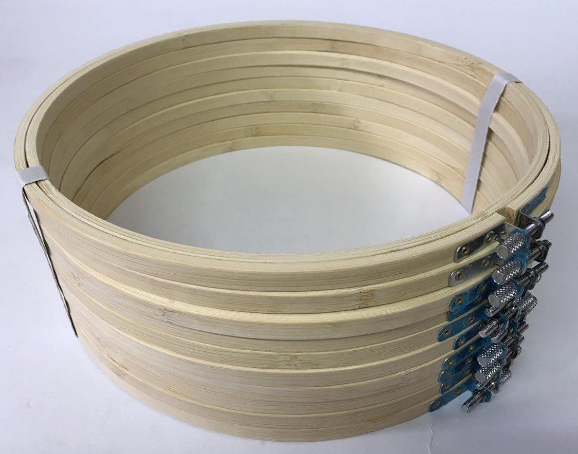 Coiled light wood slats forming a circular hoop, secured with metal clamps on the right side