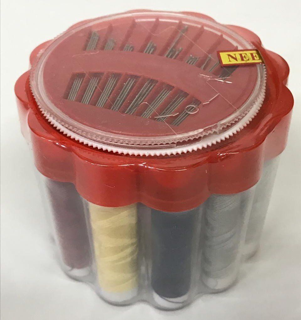 Red plastic sewing kit case with clear sides showing spools of thread and needles inside.
