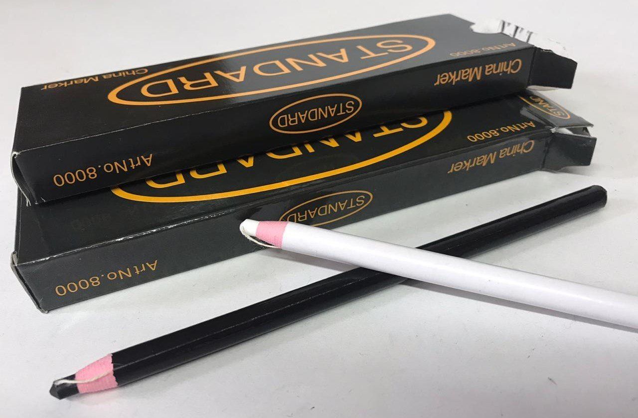 Three black eyeliner pencils with pink tips, stacked on a white surface.