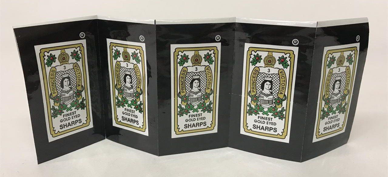 Accordion-fold greeting card with black panels and ornate floral artwork on a white surface