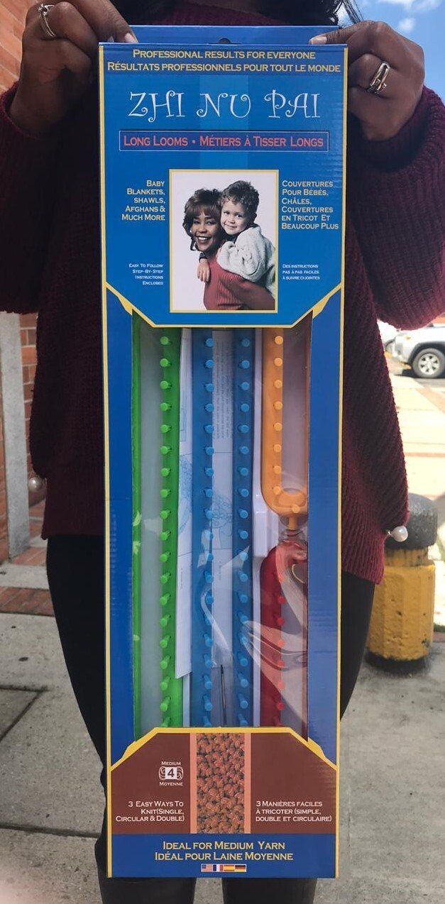 Blue retail box displaying colorful plastic ribbons or sticks with a small photo near the top