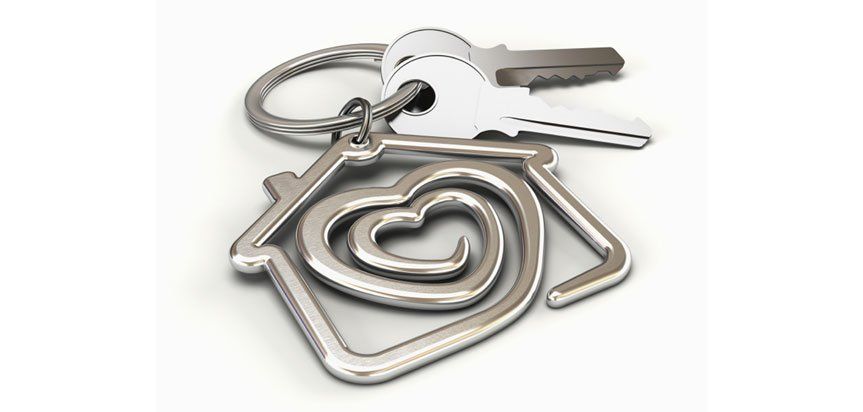 A key chain with a house and a heart on it.