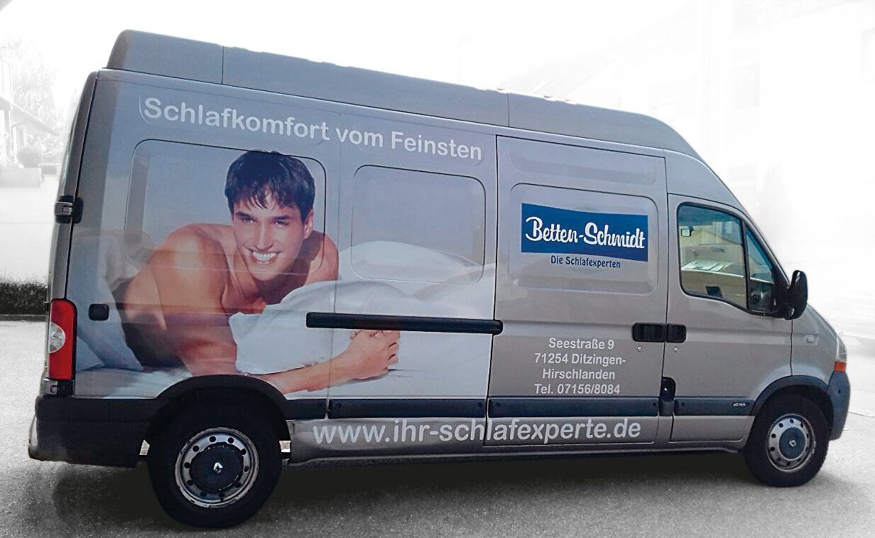 Delivery van with advertisement: Smiling man in bed, text
