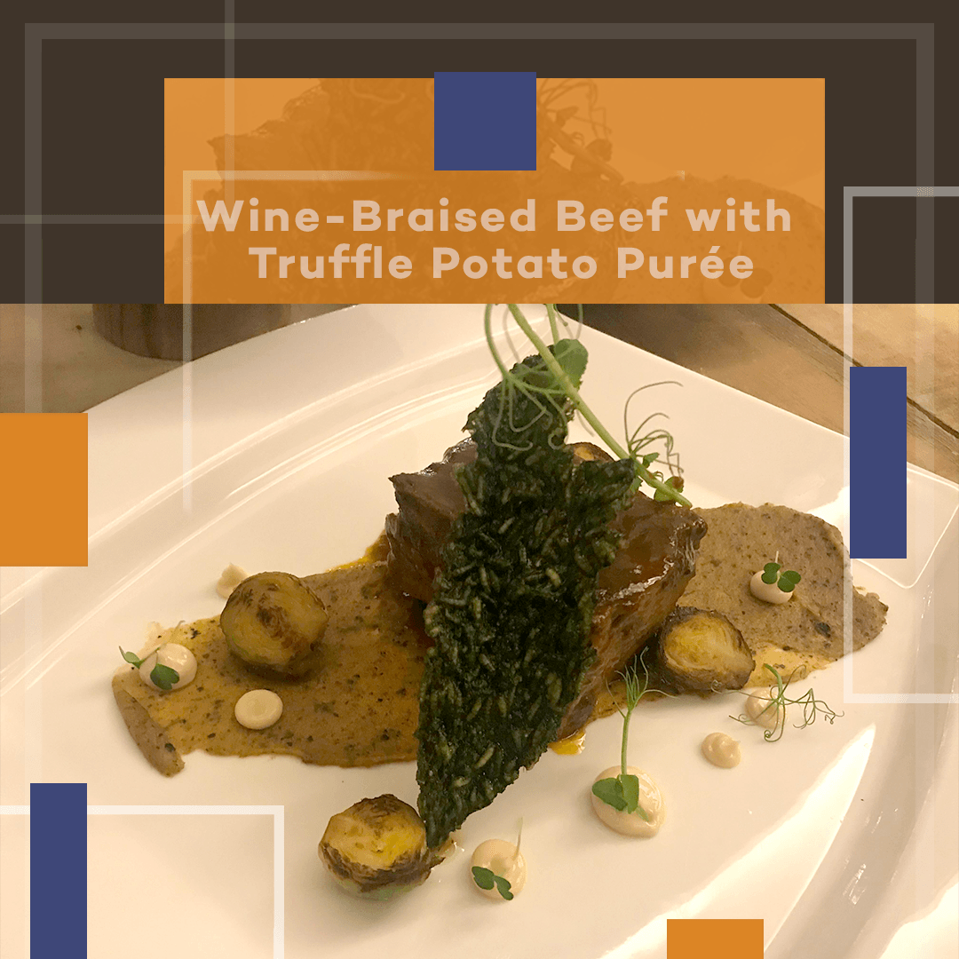 Wine-braised beef with truffle potato purée on a white plate, garnished with herbs and sauce.