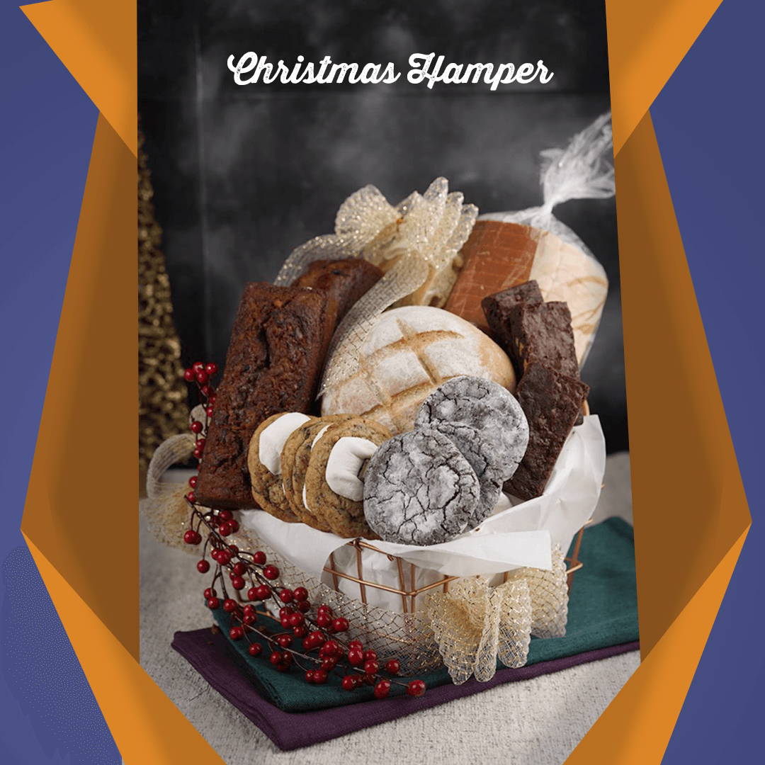 Holiday bread basket with assorted loaves, red berries, and “Christmas hamper” text on a dark backdrop
