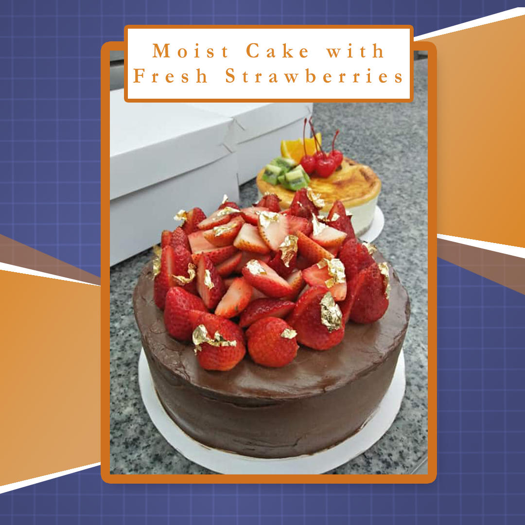 Chocolate cake topped with fresh strawberries and a smaller fruit-topped cake behind it