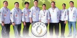 Group of people in white shirts posing with a “Global” logo badge centered in front