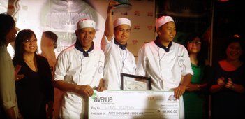 People on stage holding a large check and framed certificate at an awards event