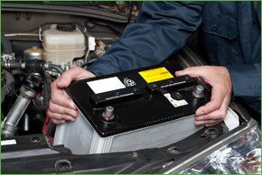 One of the mechanics repairing a car engine
