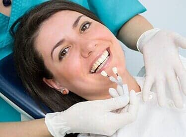 Smiling woman lying in a dental chair — Dental Office in Virginia Beach, VA Smiling woman lying in a dental chair — Dental Office in Virginia Beach, VA