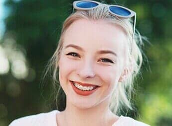 Beautiful girl smiling with braces — Dental Office in Virginia Beach, VA Beautiful girl smiling with braces — Dental Office in Virginia Beach, VA