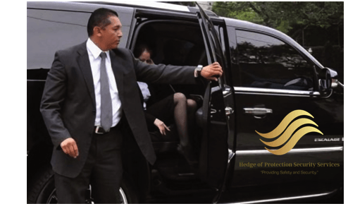 Man in a black suit opening a black car door with gold logo and lettering on the side