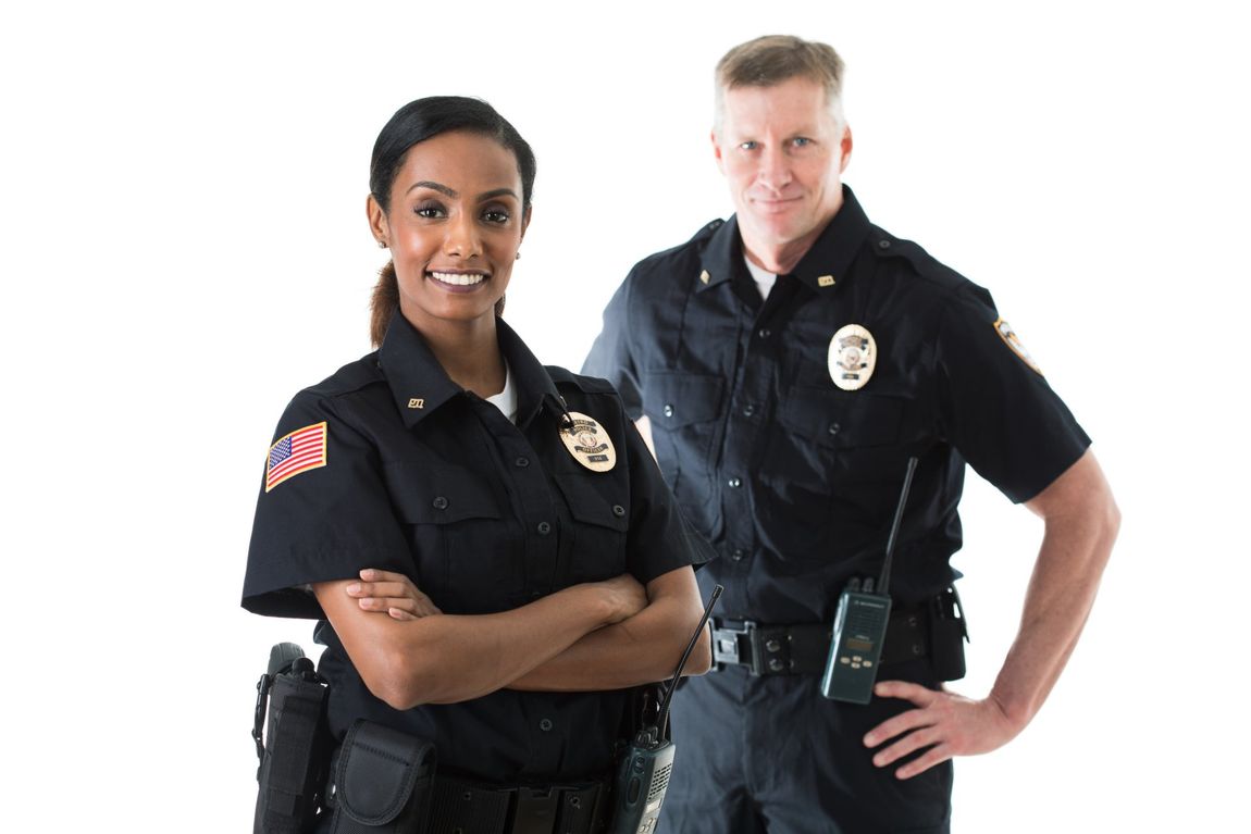 Two uniformed police officers posing with arms crossed against a white background