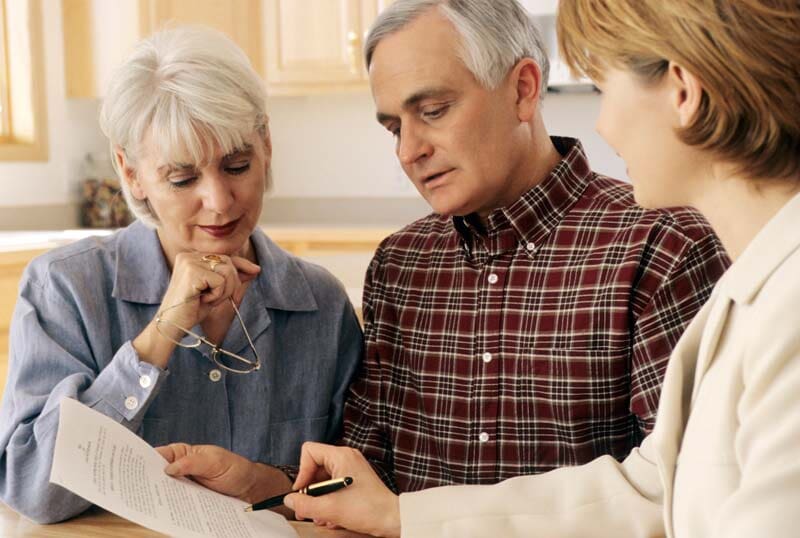 Woman Explaining Document To An Old Couple — Royal Oak, MI — Melder & Melder, P.C.
