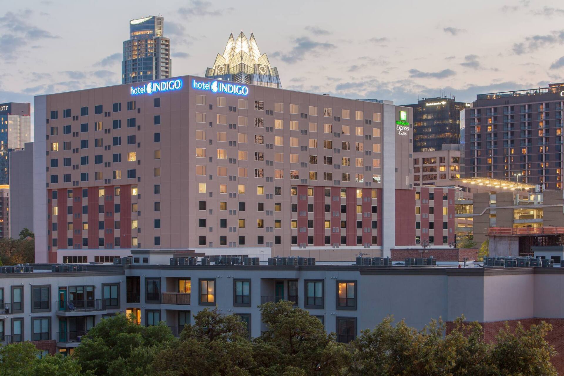 Hotel Van Zandt and a Holiday Inn hotel in Austin, Texas, with downtown skyline in the background.