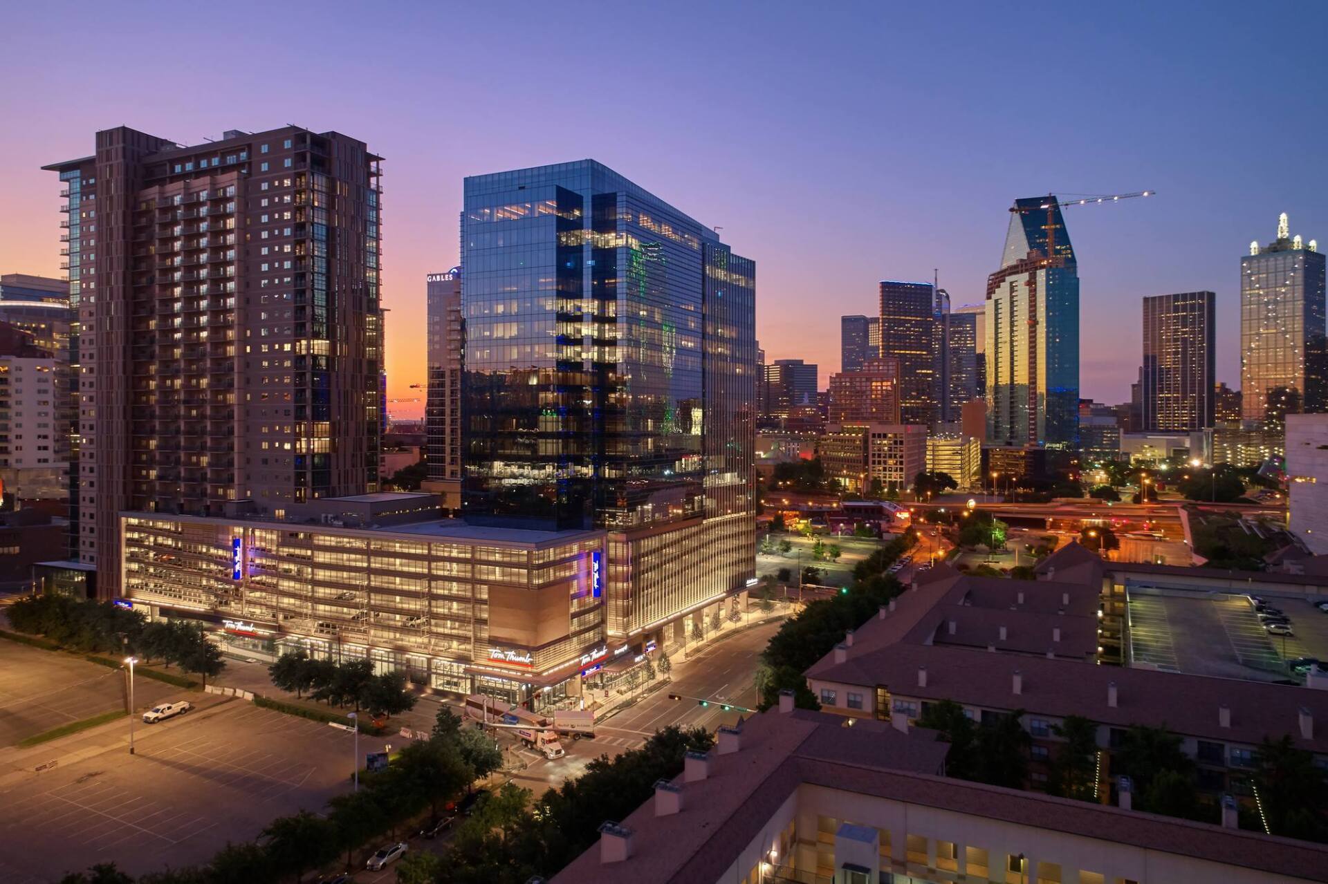 City skyline at dusk with lit skyscrapers.