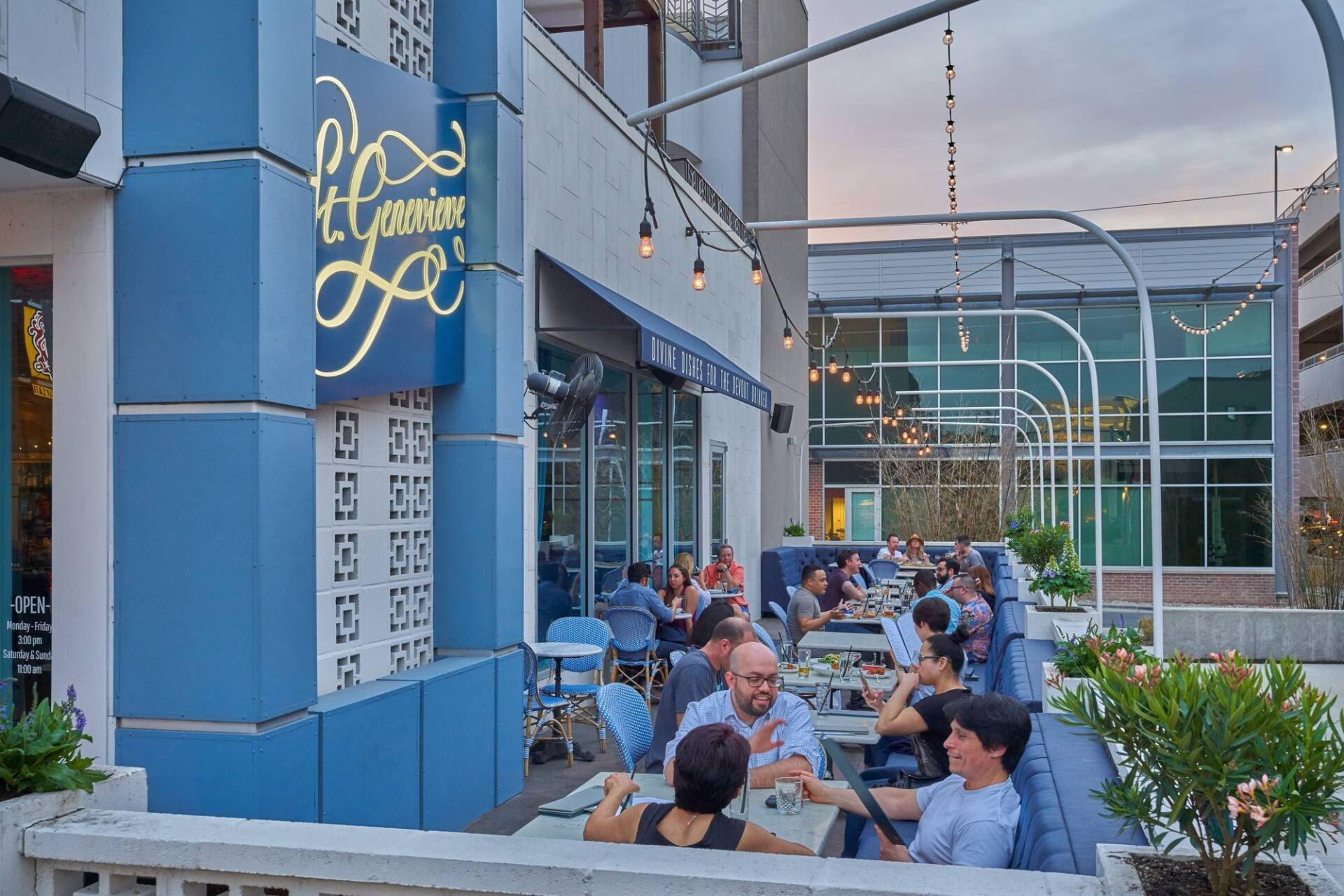 El Camino LA restaurant exterior with outdoor seating. Blue facade, people dining, string lights.